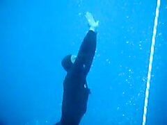 Masked And Barefaced French Freedivers Underwater